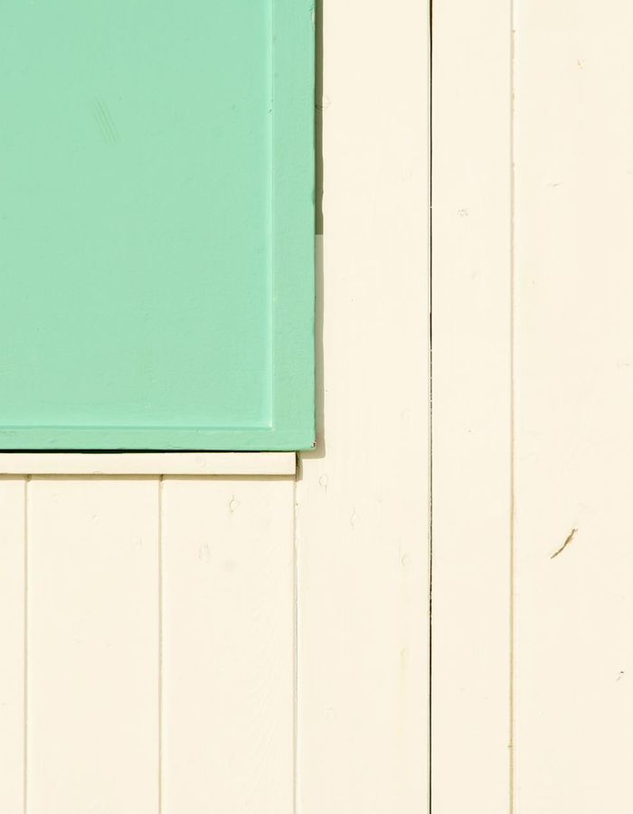 Symmetric composition with mint green elements on dark background