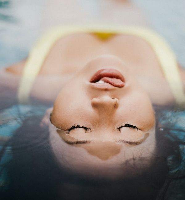 Person meditating peacefully with a calm expression on their face.